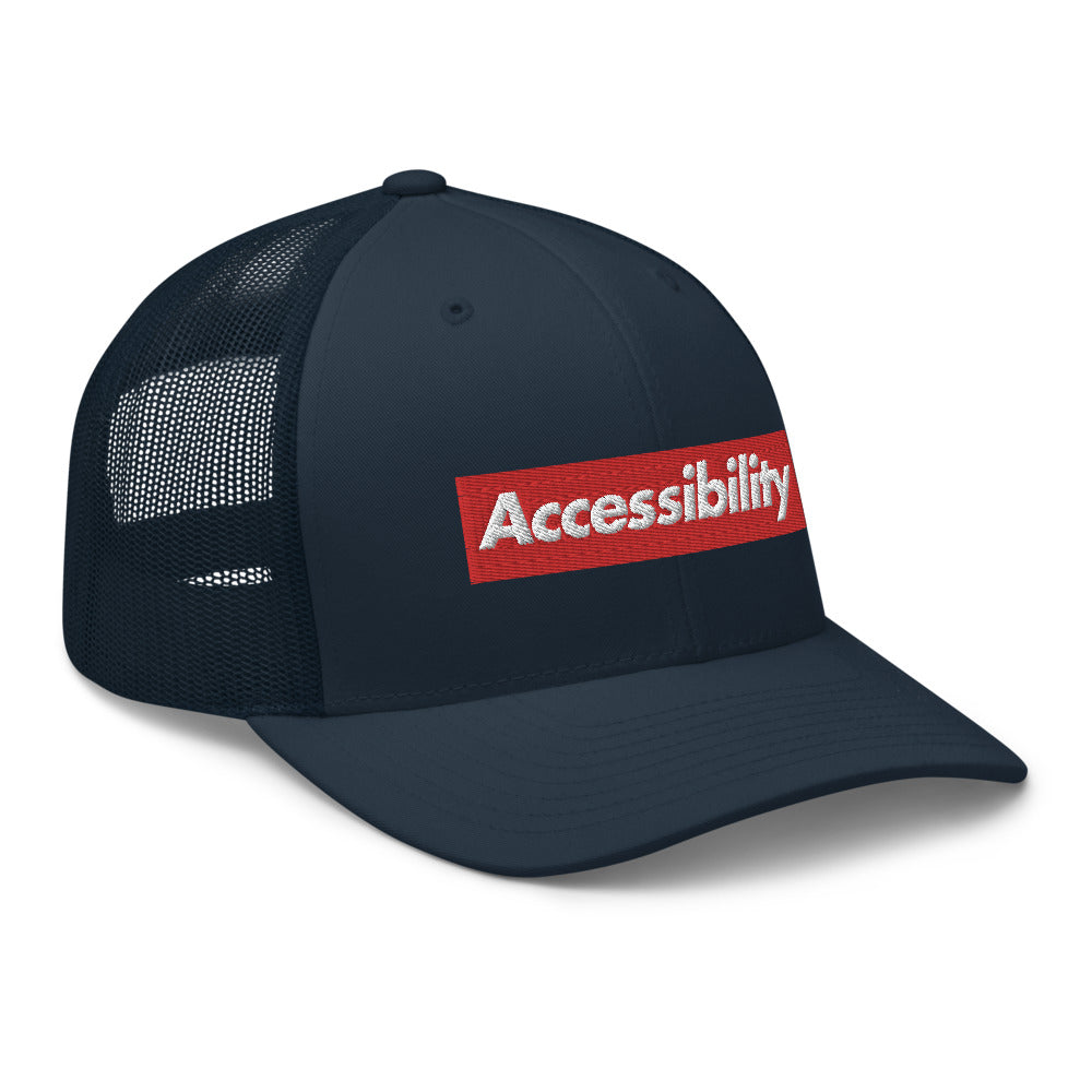 Angle view of all-blue trucker hat shows text logo design on front of hat with mesh backing.