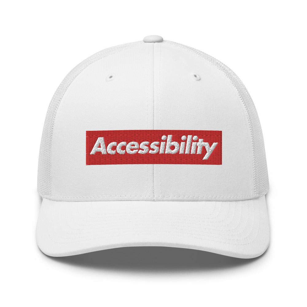White, bold, slightly italic Accessibility word on red background, on white trucker hat with white mesh backing.